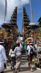 Families climb steps to decorated Balinese temple in Kintamani