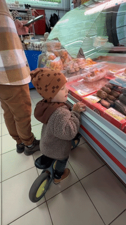 Morning café scene captures child and adult customer in Rusanovo