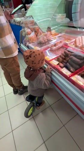 Morning café scene captures child and adult customer in Rusanovo