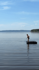 Person stands on inflatable raft in Russian lake