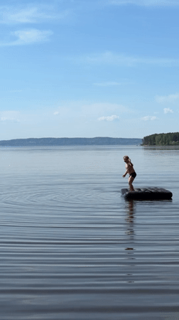 Person stands on inflatable raft in Russian lake