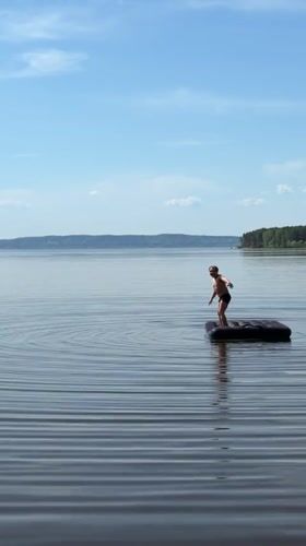 Person stands on inflatable raft in Russian lake