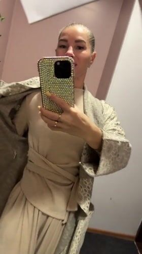 Woman records selfie video in Abakan home stairway