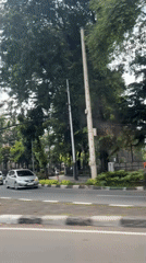 Vehicle footage captures Jakarta street scene with cathedral structure