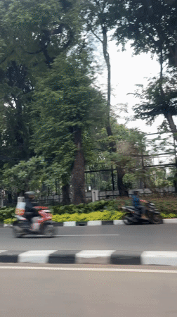 Vehicle footage captures Jakarta street scene with cathedral structure