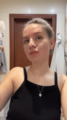 Woman documents skincare routine in Klin bathroom