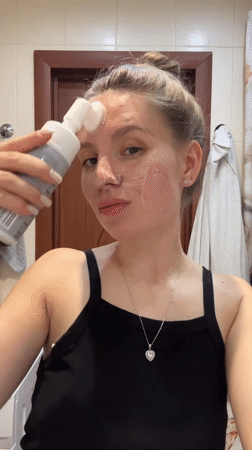 Woman documents skincare routine in Klin bathroom