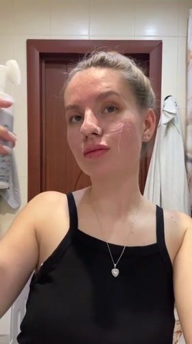 Woman documents skincare routine in Klin bathroom