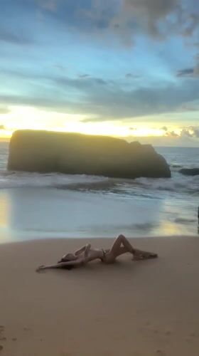 Woman relaxes on Ahungalla beach during golden hour