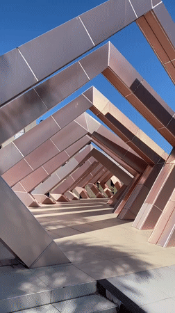 Banjarbaru's rose-gold plaza sculpture draws visitors on a sunny afternoon