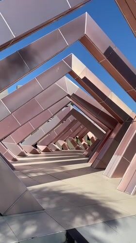 Banjarbaru's rose-gold plaza sculpture draws visitors on a sunny afternoon