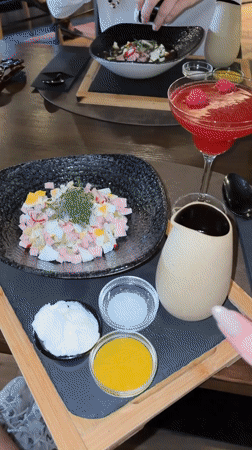 Pouring salad dressing at lunch in Madrid