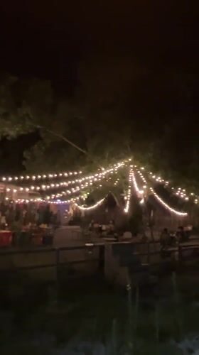 Nighttime Ko Samui: lit outdoor venue and waterfront walkway