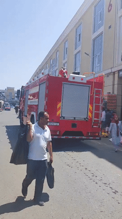 Fire truck parked outside Akbar Premium building in Tursunzoda