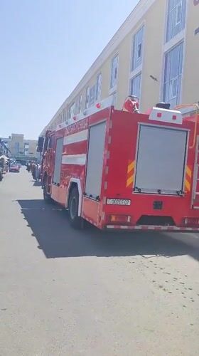 Fire truck parked outside Akbar Premium building in Tursunzoda