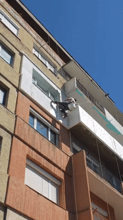 Construction workers renovate building exterior in Blagoevgrad, Bulgaria