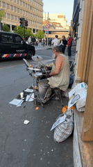 Street drummer performs on London sidewalk Friday evening