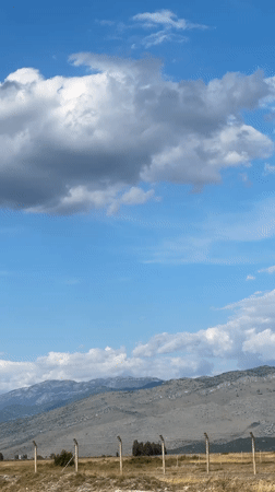 Yellow crop duster and helicopter activity over Podgorica Airport area