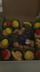 Fruit-shaped candies and meringues packed in decorative gift boxes