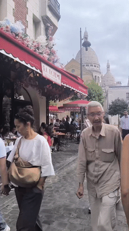A busy Montmartre morning: street art, cafés, and tourist commerce