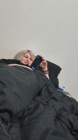 Person with blonde hair resting in bed in Bangkok