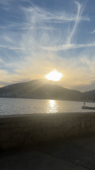 Sunset captured over water from stone wall in Budva