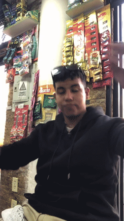 Young man takes selfies in Juan Griego store