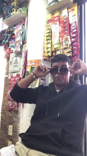 Young man takes selfies in Juan Griego store