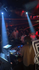 DJ with braided hair performs at crowded Dubai nightclub