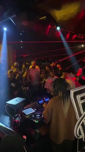 DJ with braided hair performs at crowded Dubai nightclub