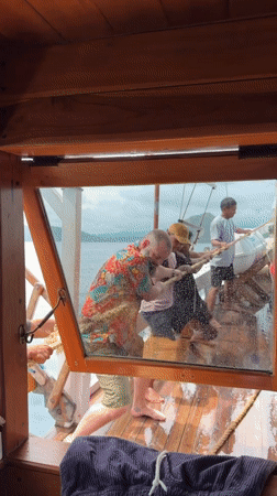 Man in floral shirt spotted aboard wooden boat in Labuan Bajo
