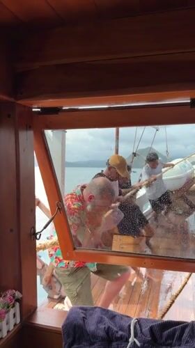 Man in floral shirt spotted aboard wooden boat in Labuan Bajo