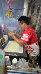 Street vendor prepares rolled ice cream in Patong