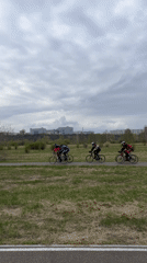 Cycling group rides through Krasnoyarsk green space toward city