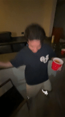 Young man dances with cup and cigarette in Mexico