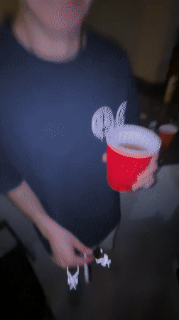 Young man dances with cup and cigarette in Mexico