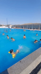 Sunny day at a crowded outdoor water park and pool