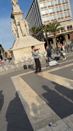 Violinist performs street music in Catania plaza
