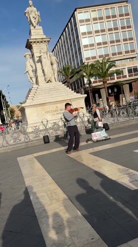 Violinist performs street music in Catania plaza