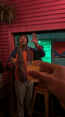 Men share celebratory toast at São Paulo bar