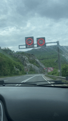 Driver approaches tunnel on Montenegro highway under overcast skies