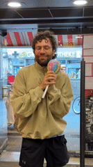 Man enjoys treats while shopping at Berlin store