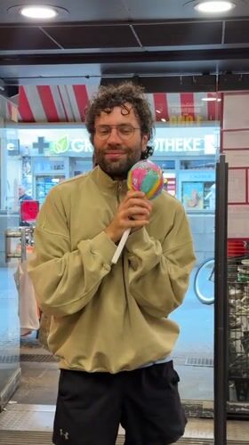 Man enjoys treats while shopping at Berlin store