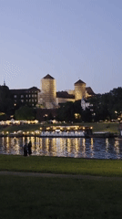 Wawel Castle glowing at twilight above the Vistula