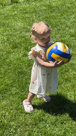 Family volleyball gathering features toddler in Grünberg, Germany