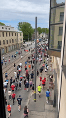 Marathon runners of varied ages race through Riga streets
