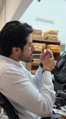 Man lights cigarette in office chair in Puebla
