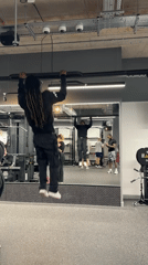 Man performs pull-ups at London gym