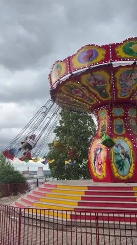 Chair swing ride operates in Izhevsk under overcast skies