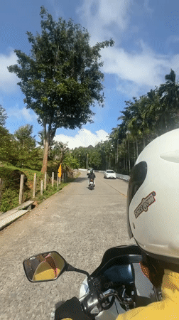 Motorcycle ride through lush Karon roads on a sunny morning